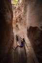 Diverse woman rock climbing in a beautiful slot canyon near Zion National Park