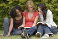 Diverse woman in a small group reading. Royalty Free Stock Photo