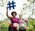 Diverse women with hashtag icon in the park Royalty Free Stock Photo
