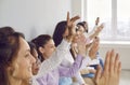 Diverse women have questions and raise their hands after a business presentation Royalty Free Stock Photo