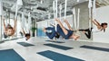 Diverse women train do fly yoga at fitness class Royalty Free Stock Photo