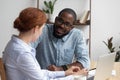 Diverse coworkers talking having pleasant conversation in office