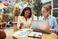 Smiling businesswomen using a laptop in an office lounge Royalty Free Stock Photo