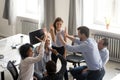 Diverse young colleagues give high five engaged in teambuilding Royalty Free Stock Photo