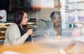 Diverse young friends talking together inside of a cafe Royalty Free Stock Photo