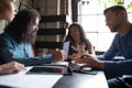 Diverse young multiethnic business partners having informal meeting at cafe Royalty Free Stock Photo