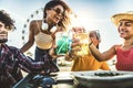 Diverse young people celebrating cheering cocktail glasses outside - Happy group of friends having fun together on summer vacation Royalty Free Stock Photo