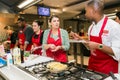 Diverse young people learning to cook and bake at a cooking class Royalty Free Stock Photo