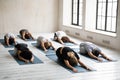 Diverse young people relaxing in Child pose, practicing yoga Royalty Free Stock Photo