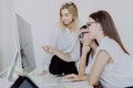 Diverse young and senior female colleagues excited by online win or business achievement. Multiracial happy businesswomen Royalty Free Stock Photo