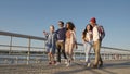 Diverse young smiling friends walking on warm day, having fun to Royalty Free Stock Photo
