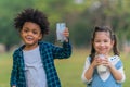 Diversed mixed race friends drinking milk together for good health in park Royalty Free Stock Photo