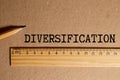 diversification. The word is written on a slip of paper,on colored background. professional terms of finance Royalty Free Stock Photo