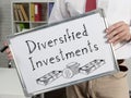 Diversified investments are shown on the photo using the text and picture of dollars