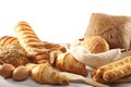 Diversity of bread and croissant, eggs, in a basket with linen c