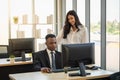 Diversity Business and Team Work concept. Young African businessman with smart businesswoman working  with desktop computer in Royalty Free Stock Photo