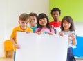 Diversity children holding blank poster in classroom at kindergarten preschool,Multiethnic Group with sign board,mock up for
