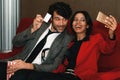 Diversity couple spend time by having selfie while waiting for movie time in theater lounge