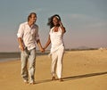 Diversity Couple walking and running on beach Royalty Free Stock Photo