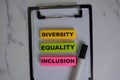 Diversity, Equality, Inclusion write on sticky notes isolated on Wooden Table Royalty Free Stock Photo