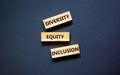 Diversity equity inclusion symbol. Concept words diversity equity inclusion on blocks on beautiful black table black background.