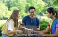 Diversity gender asian people are studying with laptop, tablet,book, notebook on table. young happy student working together in th Royalty Free Stock Photo