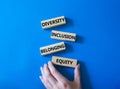 Diversity Inclusion Belonging Equity symbol. Concept words Diversity Inclusion Belonging Equity on wooden blocks. Businessman hand Royalty Free Stock Photo