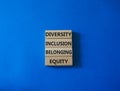 Diversity Inclusion Belonging Equity symbol. Concept words Diversity Inclusion Belonging Equity on wooden blocks. Beautiful blue Royalty Free Stock Photo