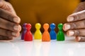 Diversity And Inclusion Concept. Hand Protecting Pawns Royalty Free Stock Photo
