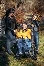 Diversity and inclusion. Happy family, mother, daughter and son teen boy with cerebral palsy spending time together in Royalty Free Stock Photo