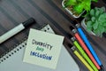 Diversity and Inclusion write on sticky notes isolated on Wooden Table Royalty Free Stock Photo