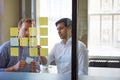 Diversity is a key ingredient to fresh ideas. two businessmen preparing for a presentation by using adhesive notes.