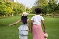 Diversity of LGBTQ+ lesbian couple is relaxingly holding their hand together in public park during summer season to enjoy the