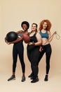 Diversity Models. Different Ethnicity And Size Women. Smiling Multicultural Friends In Sportswear Holding Fitness Equipment.