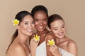 Diversity. Natural Beauty Portrait. Multi-Ethnic Women With Tropical Flowers Standing Together.