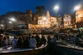 Diversity of people in many boats are watching Varanasi Ganga Aarti at holy Dasaswamedh Ghat, near Kashi Vishwanath Temple.