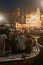 Diversity of people in many boats are watching Varanasi Ganga Aarti at holy Dasaswamedh Ghat, near Kashi Vishwanath Temple.