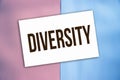 Diversity word on card put on pink and baby blue background. Teamwork equality and diversity Concept Royalty Free Stock Photo