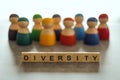 DIVERSITY word on wooden blocks with a group of different people