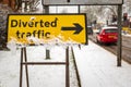 Diverted traffic sign under winter snow fall in england uk