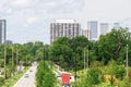 Divided highway with lots of lush foliage and green stoplight with cars and trucks and pedestrians leading to downtown Tulsa Royalty Free Stock Photo