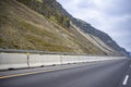 Divided highway road with car hauler big rig semi truck and rocky mountains in Columbia Gorge national recreation area Royalty Free Stock Photo