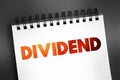 Dividend - distribution of profits by a corporation to its shareholders, text on notepad, concept background