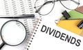 DIVIDENDS - the inscription of text on the Notepad, and chart. Business concept Royalty Free Stock Photo