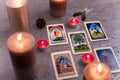 Divination cards alignment with feathers and candles on silver background. Mystery, astrology, fortune telling, belief, wisdom
