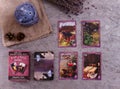 Divination cards alignment with oil burner, sackcloth, cones and dry lavender on silver background. Mystery, astrology, fortune