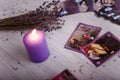 Divination cards alignment with purple burning candle and dry lavender. Mystery, astrology, occultism, fortune telling