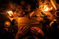 Divination with the help ancient books and of the dry African herbs. The light from the candles on the old magic table. Attributes