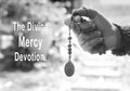 The Divine Mercy Devotion concept with a prayer hand holding The Divine Mercy rosary beads with the holy heart of Jesus Christ, Royalty Free Stock Photo
