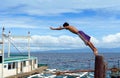 Diving Asian boy in port